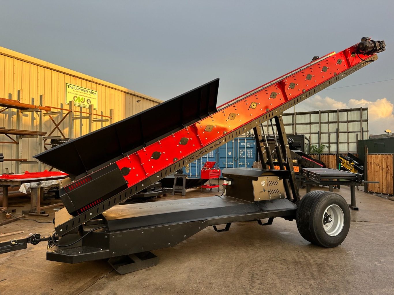 Metal processing equipment with a series of cylindrical rollers mounted on a steel frame.