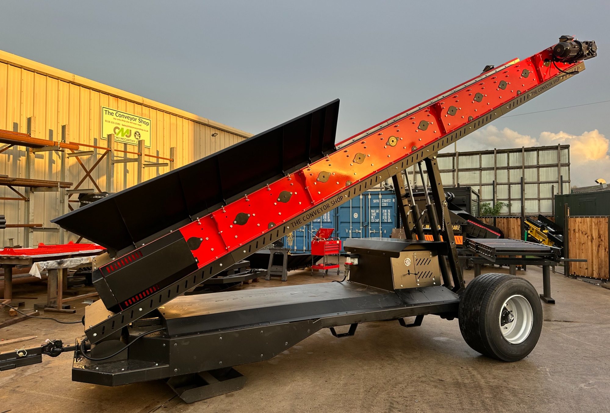 Metal processing equipment with a series of cylindrical rollers mounted on a steel frame.
